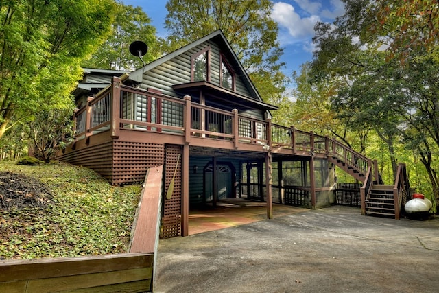112 Songbird, Blue Ridge, GA 30513 - view of front facade featuring stairway, a wooden deck, concrete driveway, and faux log siding
