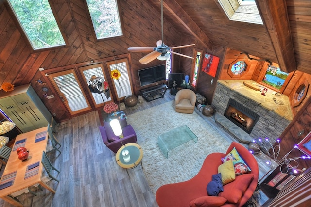 112 Songbird, Blue Ridge, GA 30513 - living room featuring a skylight, wood finished floors, wood walls, a fireplace, and high vaulted ceiling