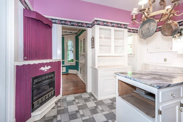 10 New Town St, Tate, GA 30177 - kitchen with white cabinetry, a chandelier, tile patterned floors, light stone countertops, and a fireplace