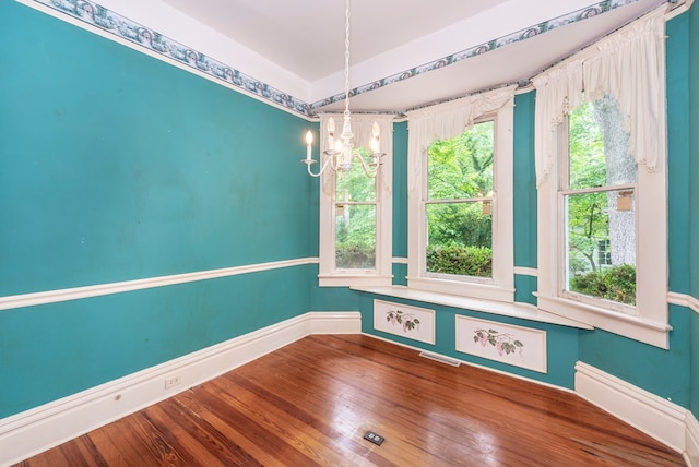 10 New Town St, Tate, GA 30177 - empty room featuring a chandelier, plenty of natural light, baseboards, and wood finished floors