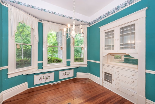 10 New Town St, Tate, GA 30177 - unfurnished dining area with a chandelier, wood finished floors, and baseboards