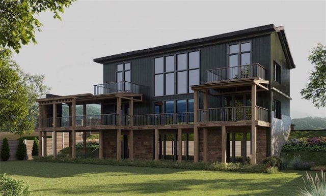 rear view of house featuring a yard and a balcony