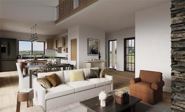 living room with light hardwood / wood-style flooring and a high ceiling