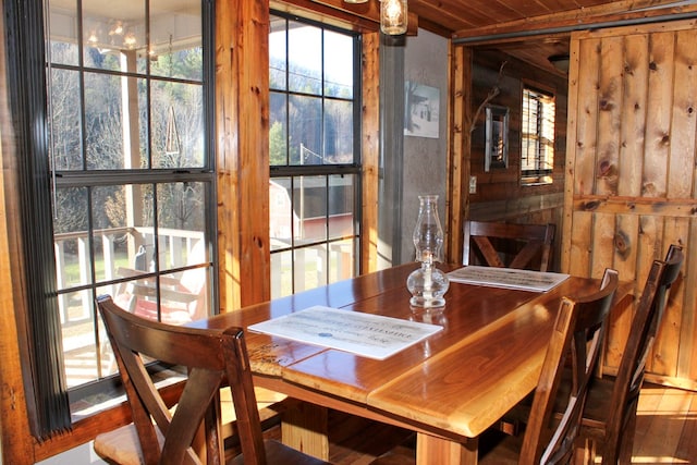 dining area with hardwood / wood-style floors and wooden ceiling