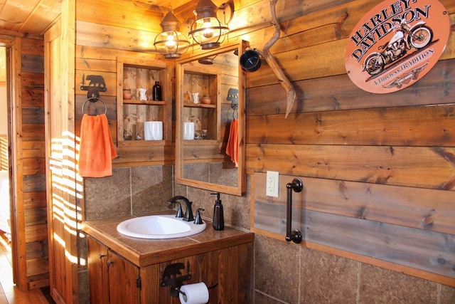 bathroom with decorative backsplash, vanity, wood ceiling, and wood walls