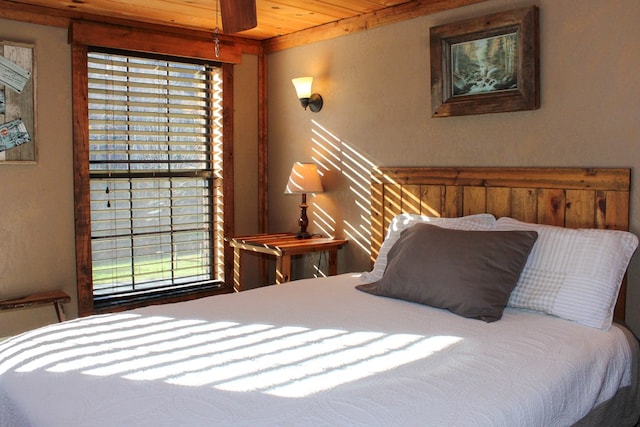 bedroom featuring wood ceiling and multiple windows