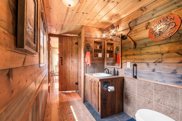 3660 Downings Creek Rd, Hayesville, NC 28904 - half bath featuring vanity, wooden walls, toilet, wooden ceiling, and hardwood / wood-style flooring