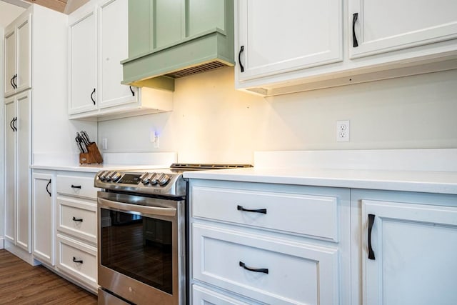 kitchen featuring white cabinetry, dark hardwood / wood-style flooring, stainless steel electric stove, and custom exhaust hood