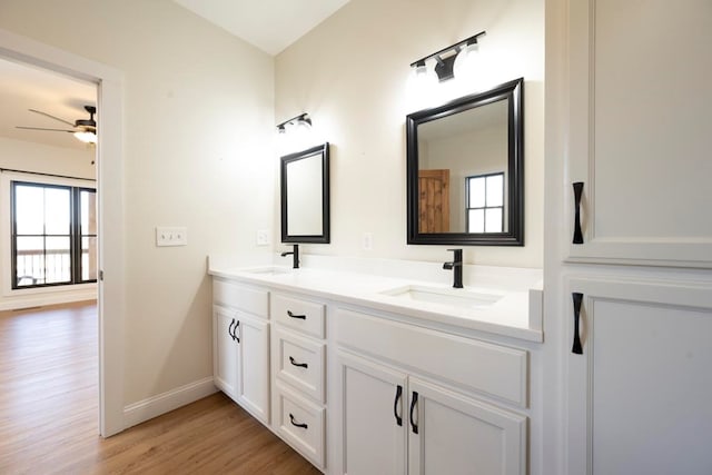 bathroom featuring wood-type flooring, vanity, and ceiling fan