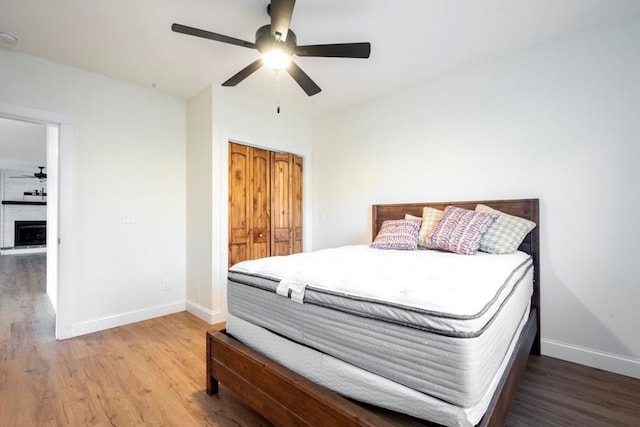 bedroom featuring ceiling fan, wood-type flooring, and a closet