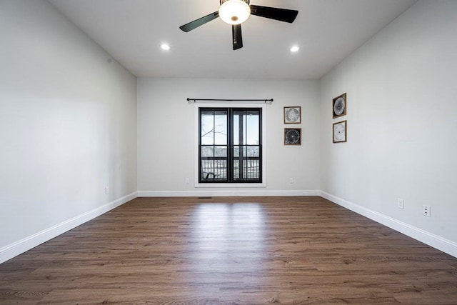 spare room with dark wood-type flooring and ceiling fan