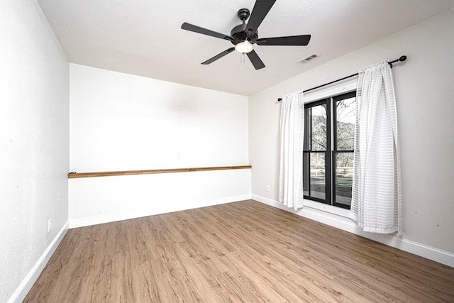 spare room featuring ceiling fan, a textured ceiling, and light wood-type flooring