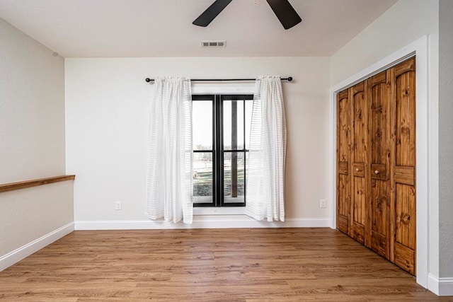 unfurnished room with ceiling fan and light wood-type flooring