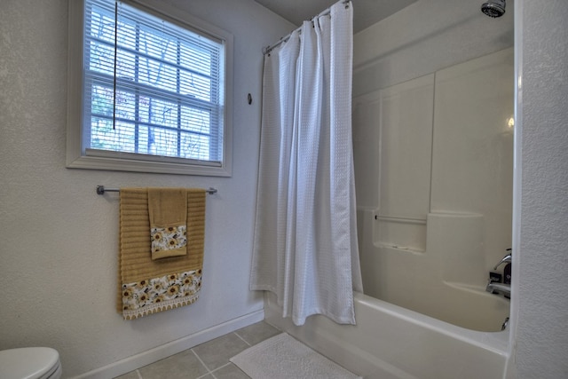 bathroom featuring tile patterned flooring, toilet, and shower / bath combo with shower curtain