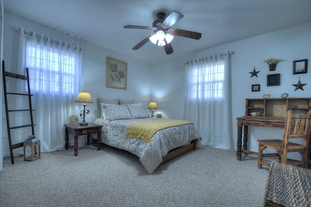 bedroom with ceiling fan and carpet flooring