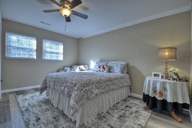 bedroom featuring wood-type flooring and ceiling fan