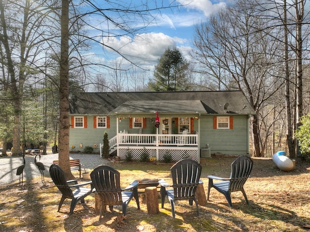 back of property featuring a fire pit and central air condition unit