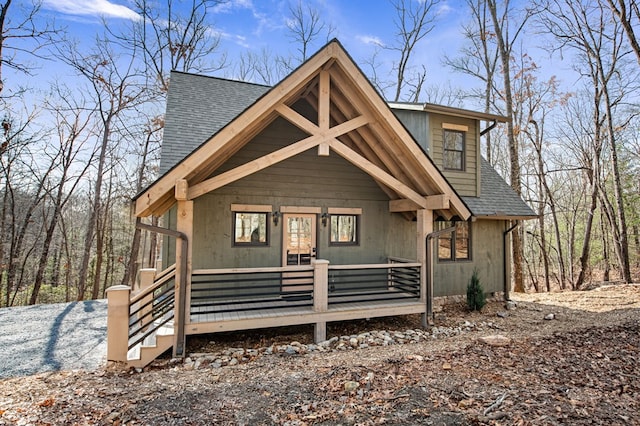 rustic home featuring a shingled roof