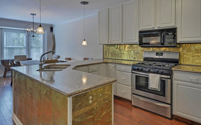 kitchen featuring dark hardwood / wood-style flooring, white cabinetry, stainless steel gas stove, and decorative light fixtures