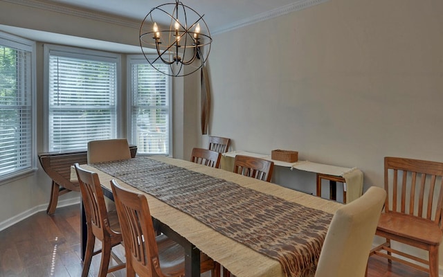 dining space featuring dark hardwood / wood-style floors, crown molding, a wealth of natural light, and an inviting chandelier