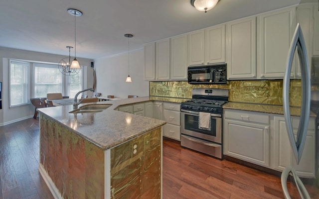 kitchen featuring stainless steel appliances, light stone counters, dark hardwood / wood-style floors, and sink