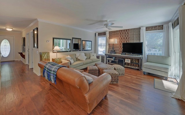 living room with hardwood / wood-style floors, ceiling fan, and ornamental molding