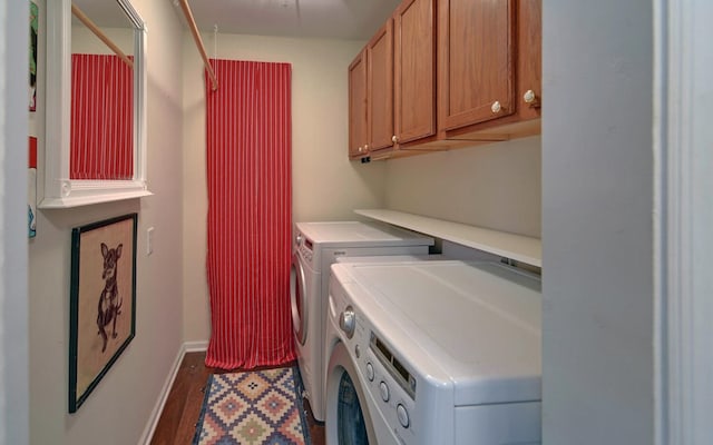 laundry area featuring cabinets, separate washer and dryer, and dark hardwood / wood-style floors