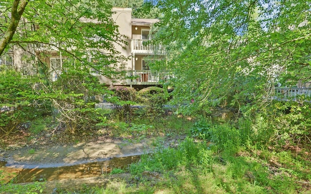 exterior space with a water view and a balcony