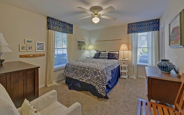 carpeted bedroom with multiple windows and ceiling fan