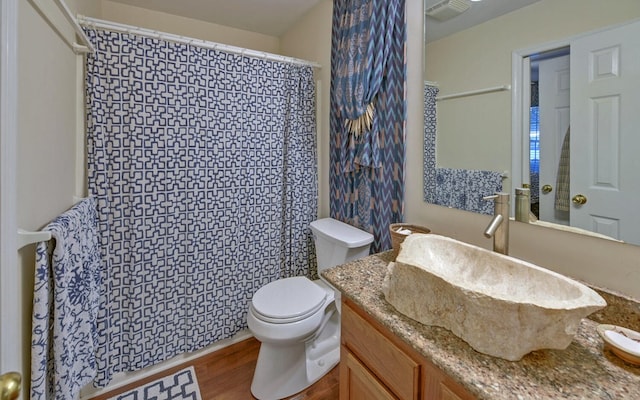 bathroom with hardwood / wood-style floors, vanity, and toilet