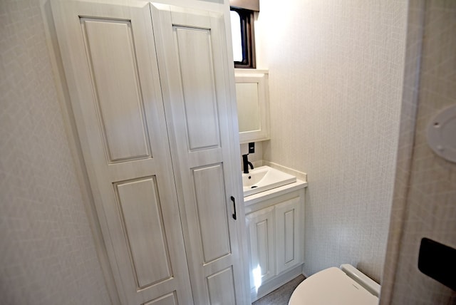 bathroom featuring toilet and vanity