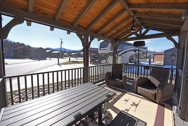 wooden deck featuring ceiling fan