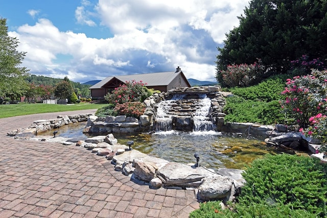 exterior space with a garden pond