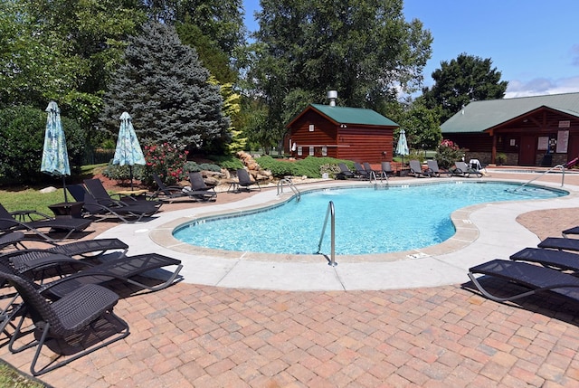 view of swimming pool with a patio