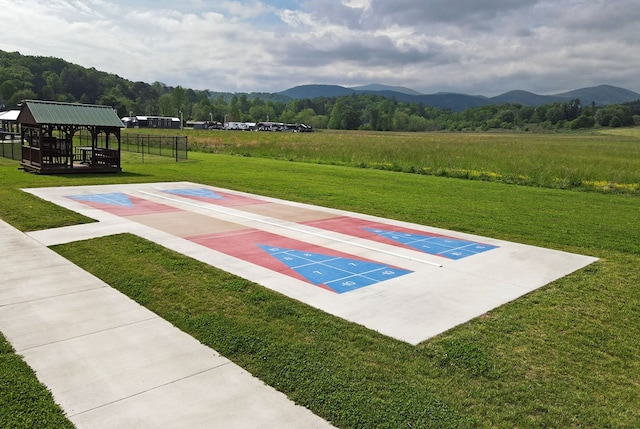 surrounding community featuring a mountain view and a lawn