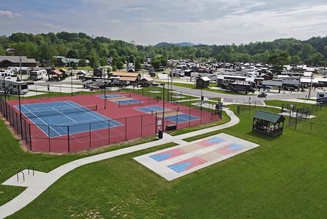 exterior space with tennis court and a yard