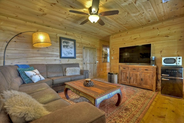 783 Moreland Dr N, Cherry Log, GA 30522 - living room featuring light hardwood / wood-style flooring, ceiling fan, wood walls, and wood ceiling