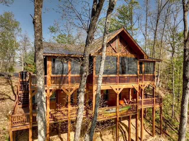 view of outdoor structure featuring a sunroom