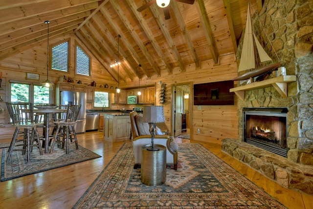 783 Moreland Dr N, Cherry Log, GA 30522 - living room with wooden walls, a fireplace, wood ceiling, light hardwood / wood-style floors, and ceiling fan