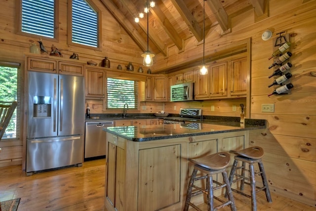 783 Moreland Dr N, Cherry Log, GA 30522 - kitchen featuring high vaulted ceiling, light hardwood / wood-style floors, appliances with stainless steel finishes, and wood walls