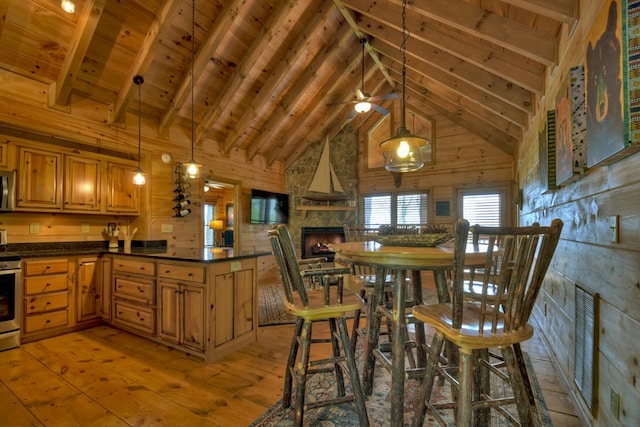 783 Moreland Dr N, Cherry Log, GA 30522 - kitchen featuring wood walls, wood ceiling, beam ceiling, light hardwood / wood-style flooring, and stainless steel range