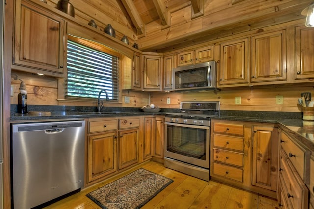 783 Moreland Dr N, Cherry Log, GA 30522 - kitchen featuring wood walls, appliances with stainless steel finishes, vaulted ceiling with beams, and light wood-type flooring