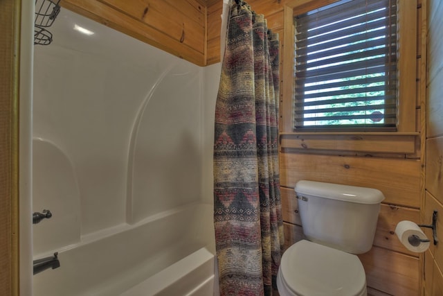 783 Moreland Dr N, Cherry Log, GA 30522 - bathroom featuring wood walls, shower / bath combination with curtain, and toilet