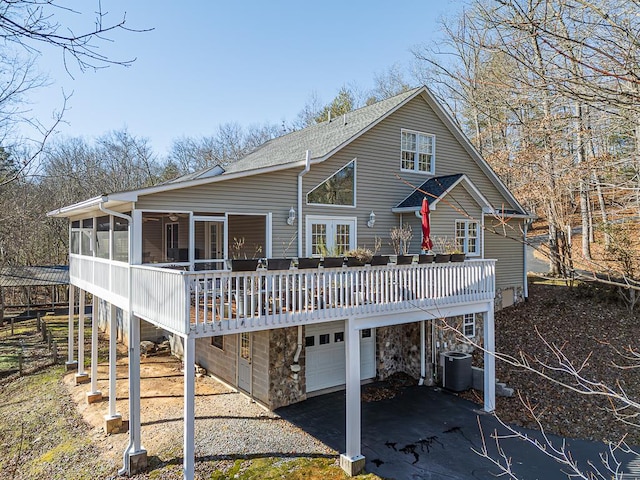 425 Tarheel Dr W, Murphy, NC 28906 - rear view of property featuring a sunroom, a garage, central air condition unit, a wooden deck, and driveway