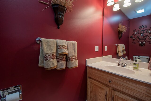 bathroom featuring toilet and vanity