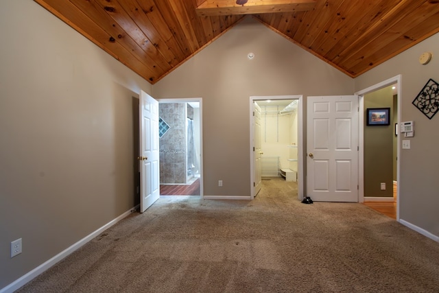 unfurnished bedroom with a spacious closet, wooden ceiling, light colored carpet, and high vaulted ceiling