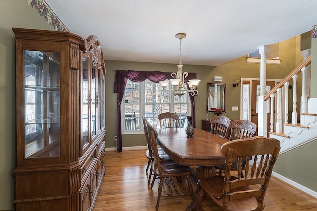 425 Tarheel Dr W, Murphy, NC 28906 - dining area with a chandelier, light wood-type flooring, baseboards, and stairs