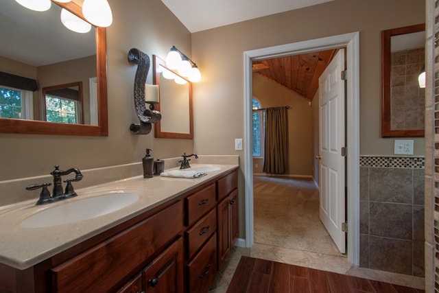 bathroom with vanity and vaulted ceiling