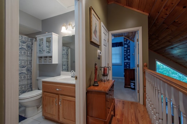 bathroom with hardwood / wood-style floors, toilet, and vanity