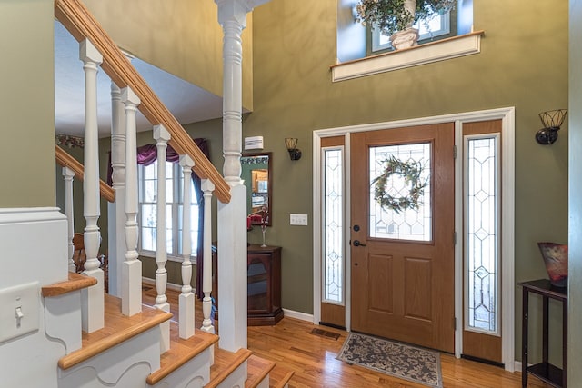 425 Tarheel Dr W, Murphy, NC 28906 - foyer entrance featuring visible vents, baseboards, a high ceiling, stairway, and wood finished floors